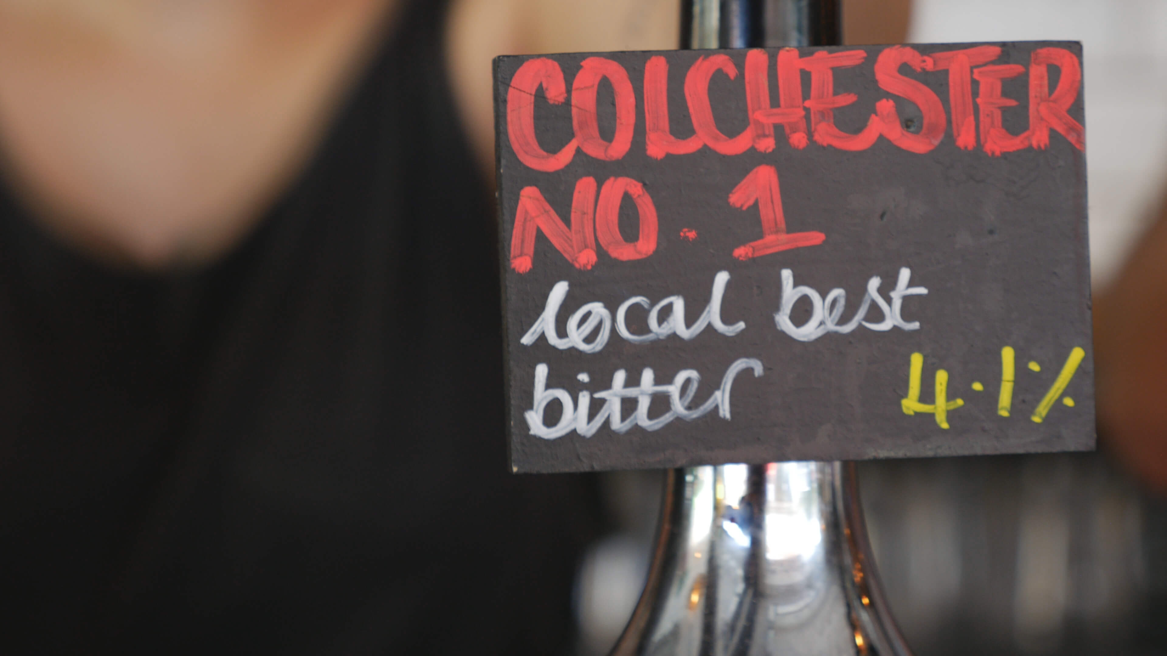 A pump clip on a bar for a beer called 'Colchester No 1'